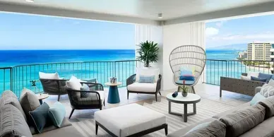 There is a large balcony with a view of the ocean.