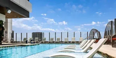 There are a lot of chairs around the pool.