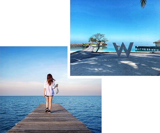 A woman is walking on a pier near the ocean