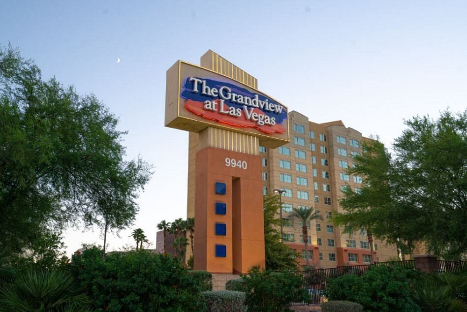 A large building with arches and a car parked in front of it.