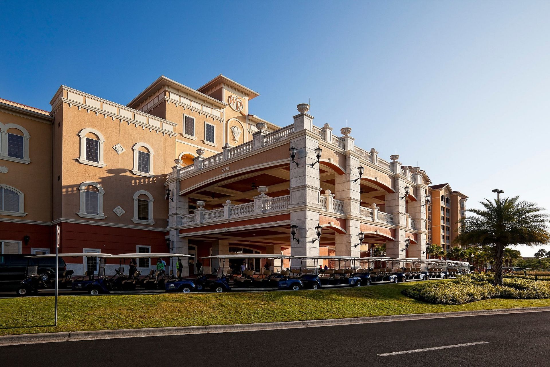 A large building with arches and a car parked in front of it.