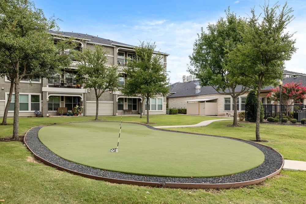 A putting green in the middle of the grass at Marquis Rockwall in Rockwall, TX.