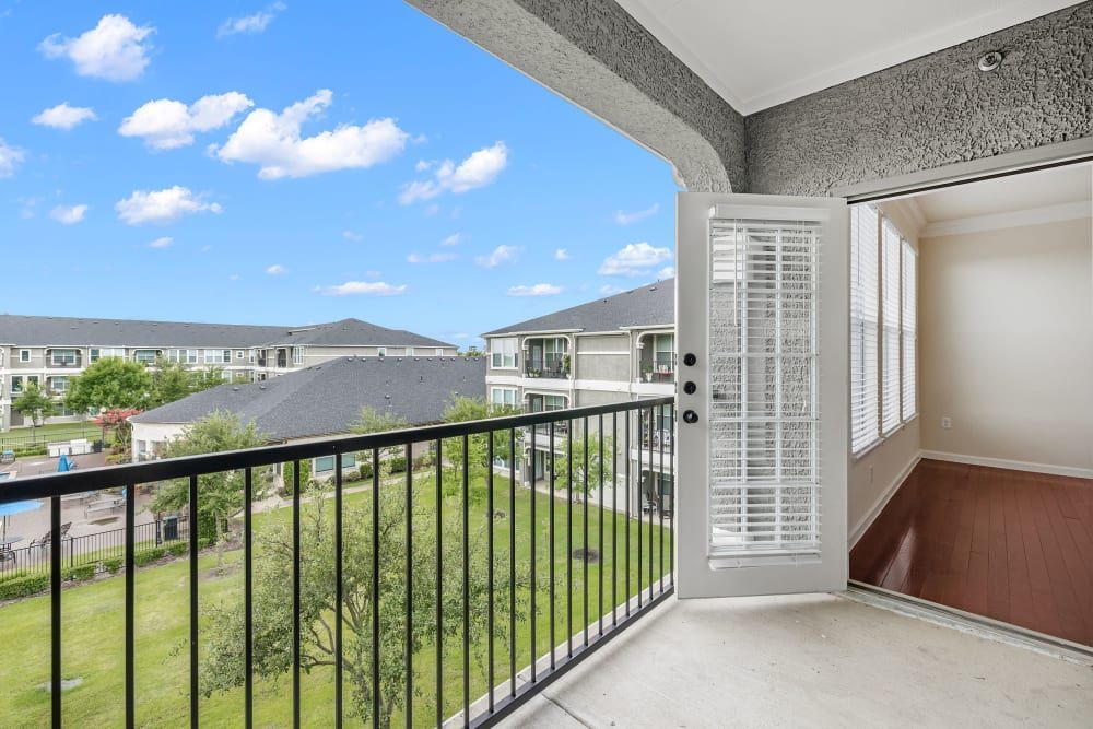 An empty balcony with a view of a residential area at Marquis Rockwall in Rockwall, TX.