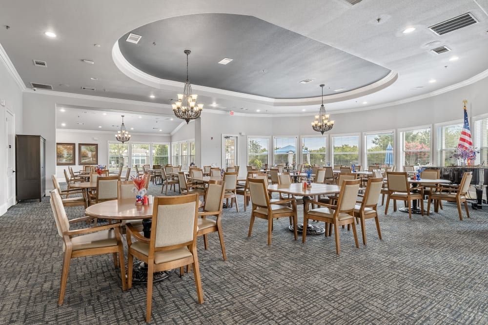 Senior living community dining room with tables and chairs at Marquis Rockwall in Rockwall, TX.