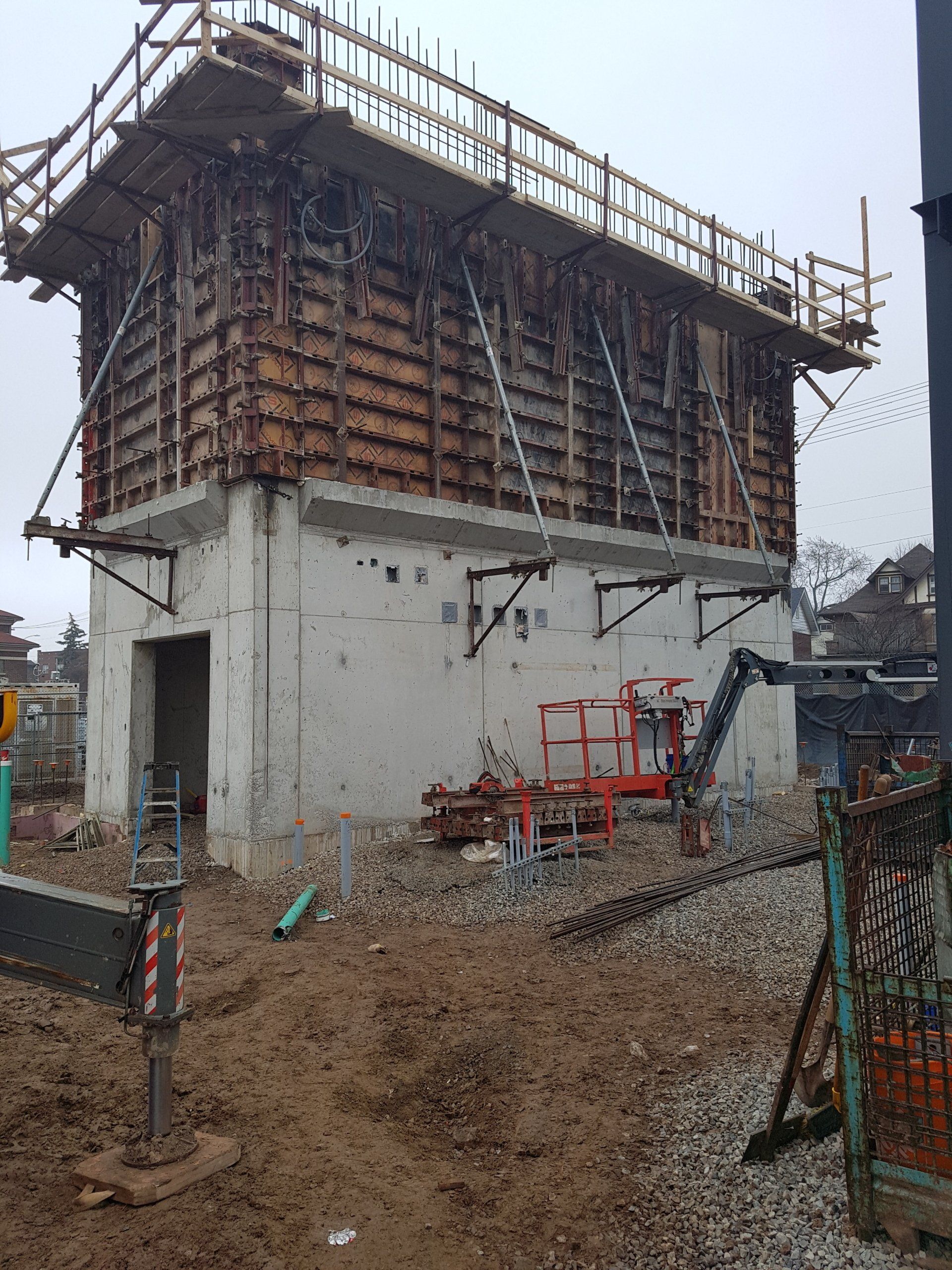 A large concrete structure is being built in a construction site.