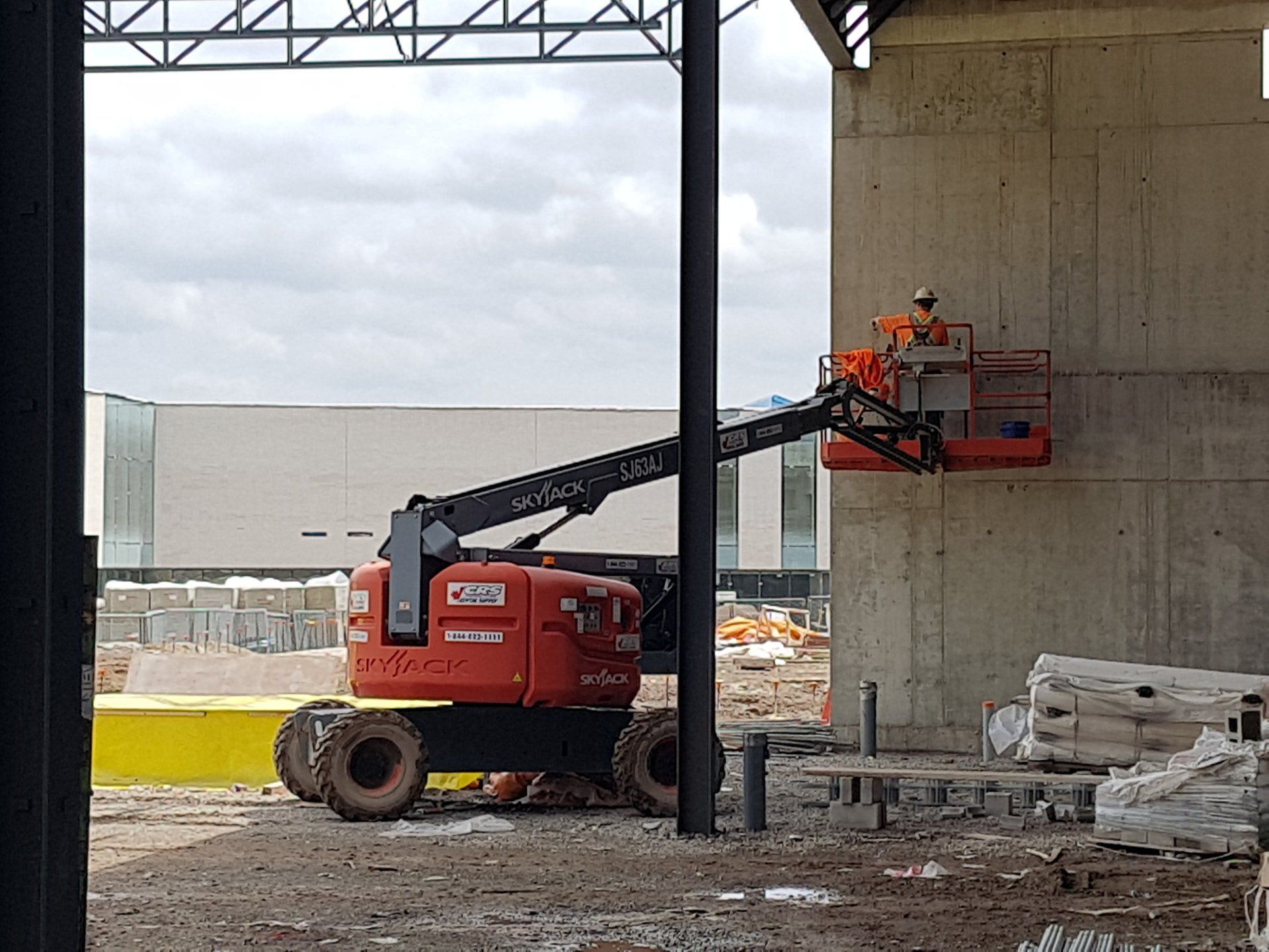 A man is working on a lift at a construction site