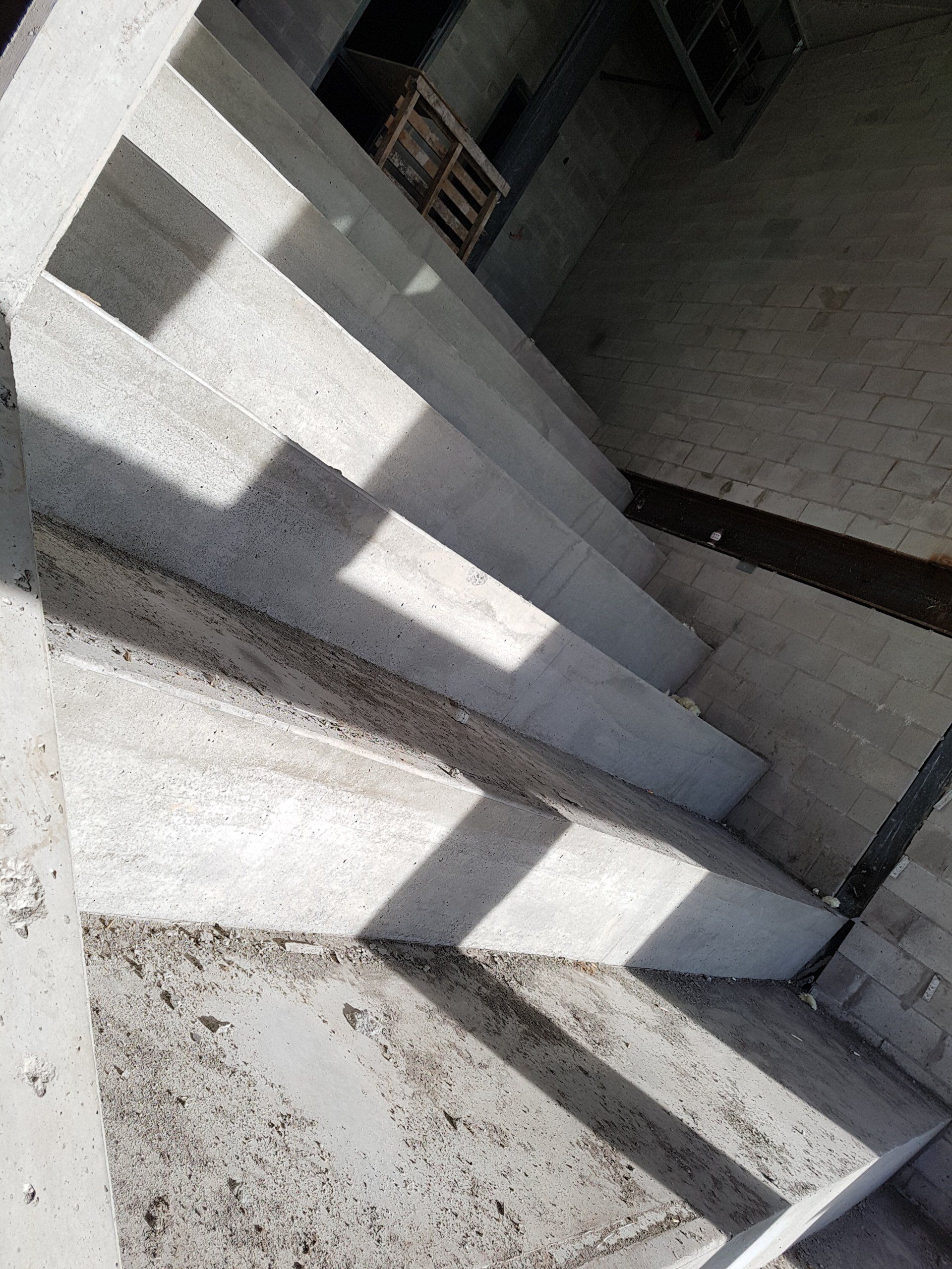 A concrete staircase is being built in a building.
