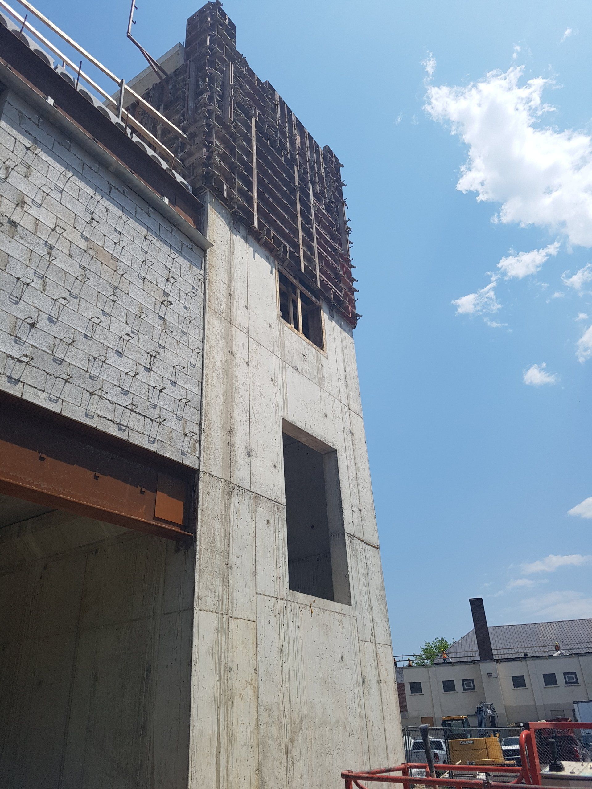 A building under construction with a blue sky in the background