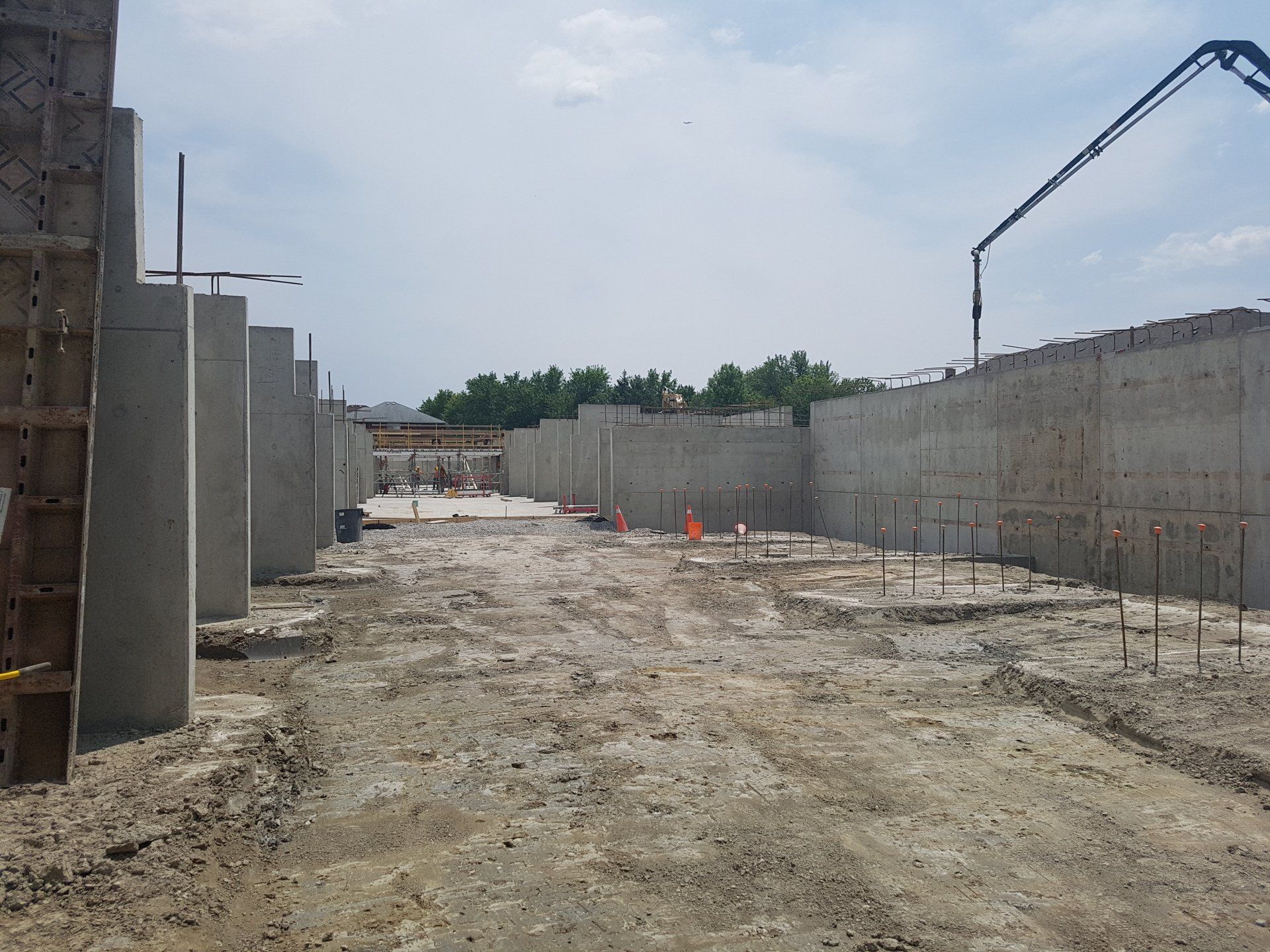 A construction site with concrete walls and a concrete pump