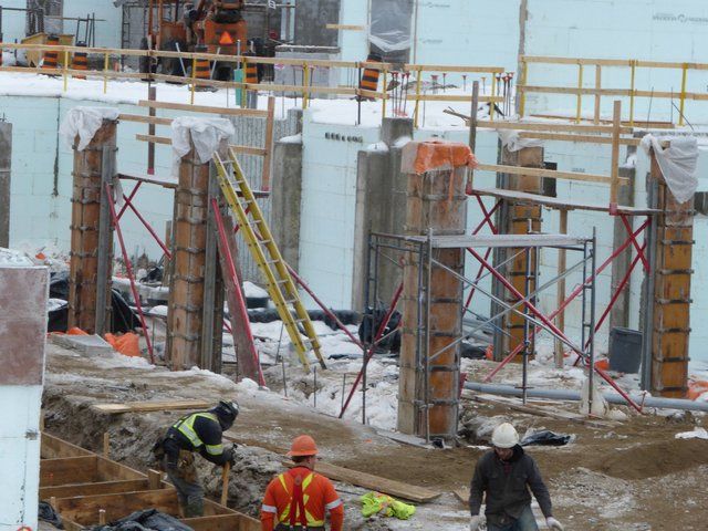 A group of construction workers are working on a building