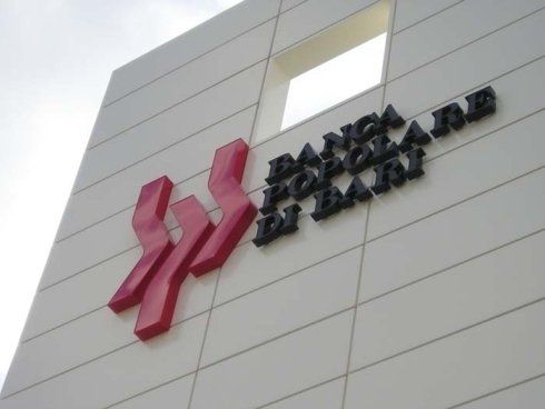 Banca Popolare di Bari logo on a white building. Red logo, black text.