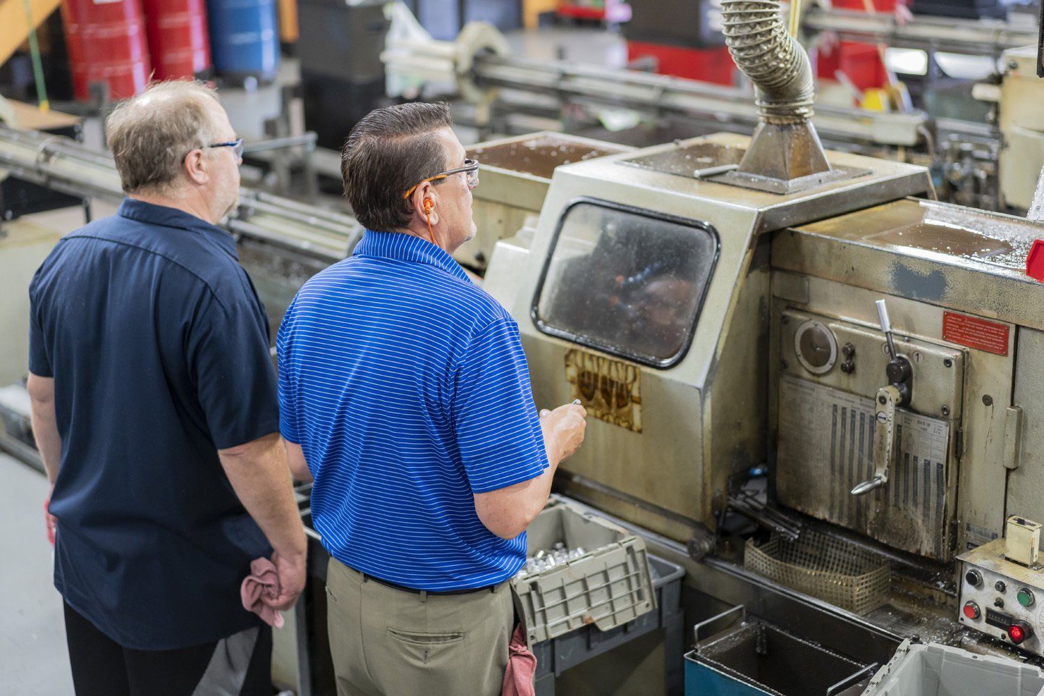 Two RIMA Manufacturing Company team members using a machine 