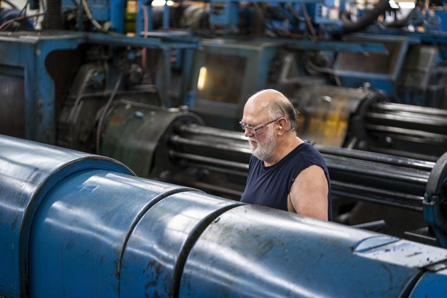 A RIMA Manufacturing Company team member using a machine
