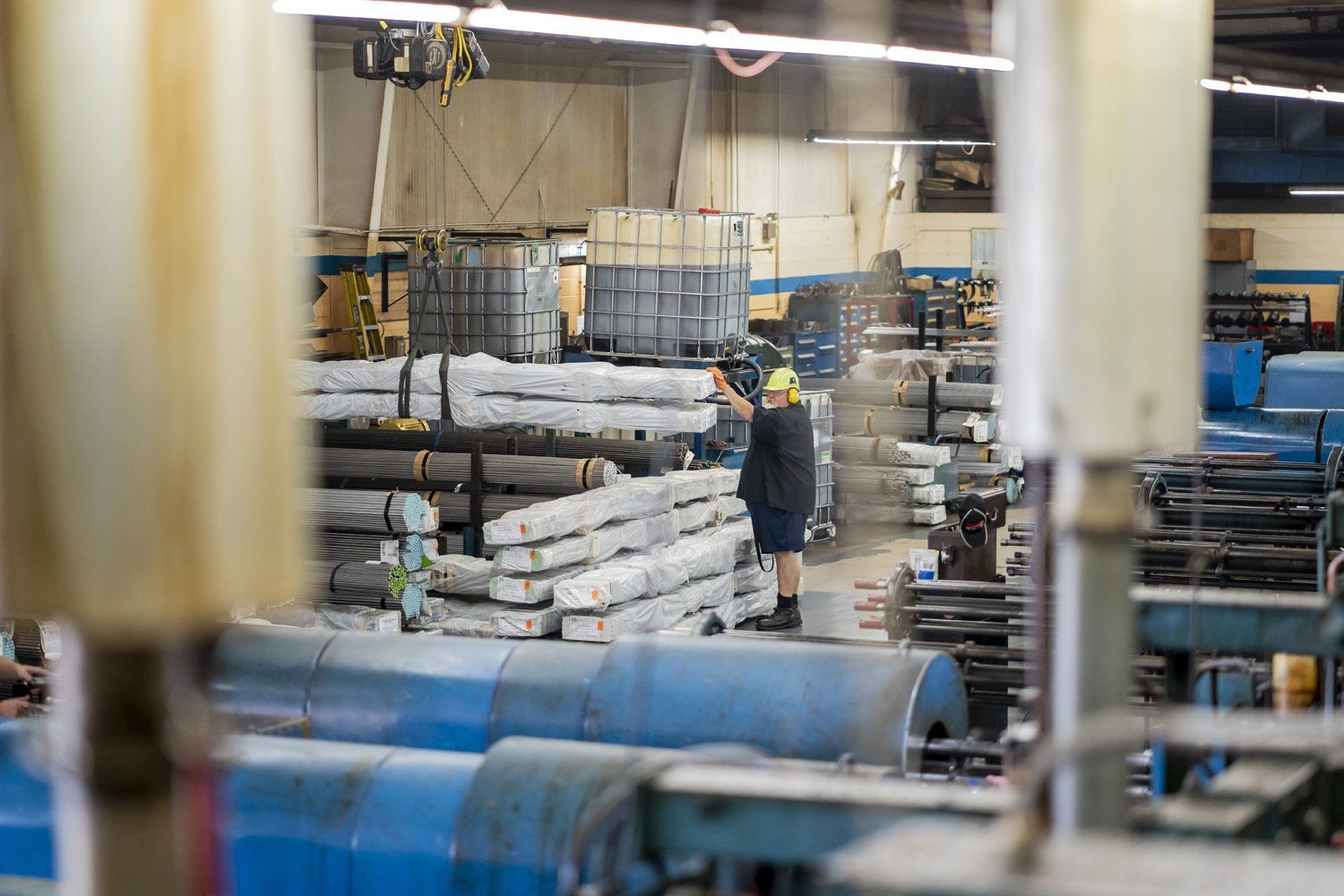 A RIMA Manufacturing Company team member by metal materials in a warehouse.
