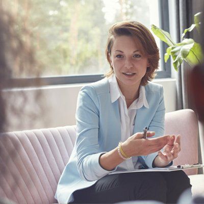Female therapist talking to couple in couples therapy session