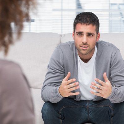 Man telling therapist his problems sitting on the couch