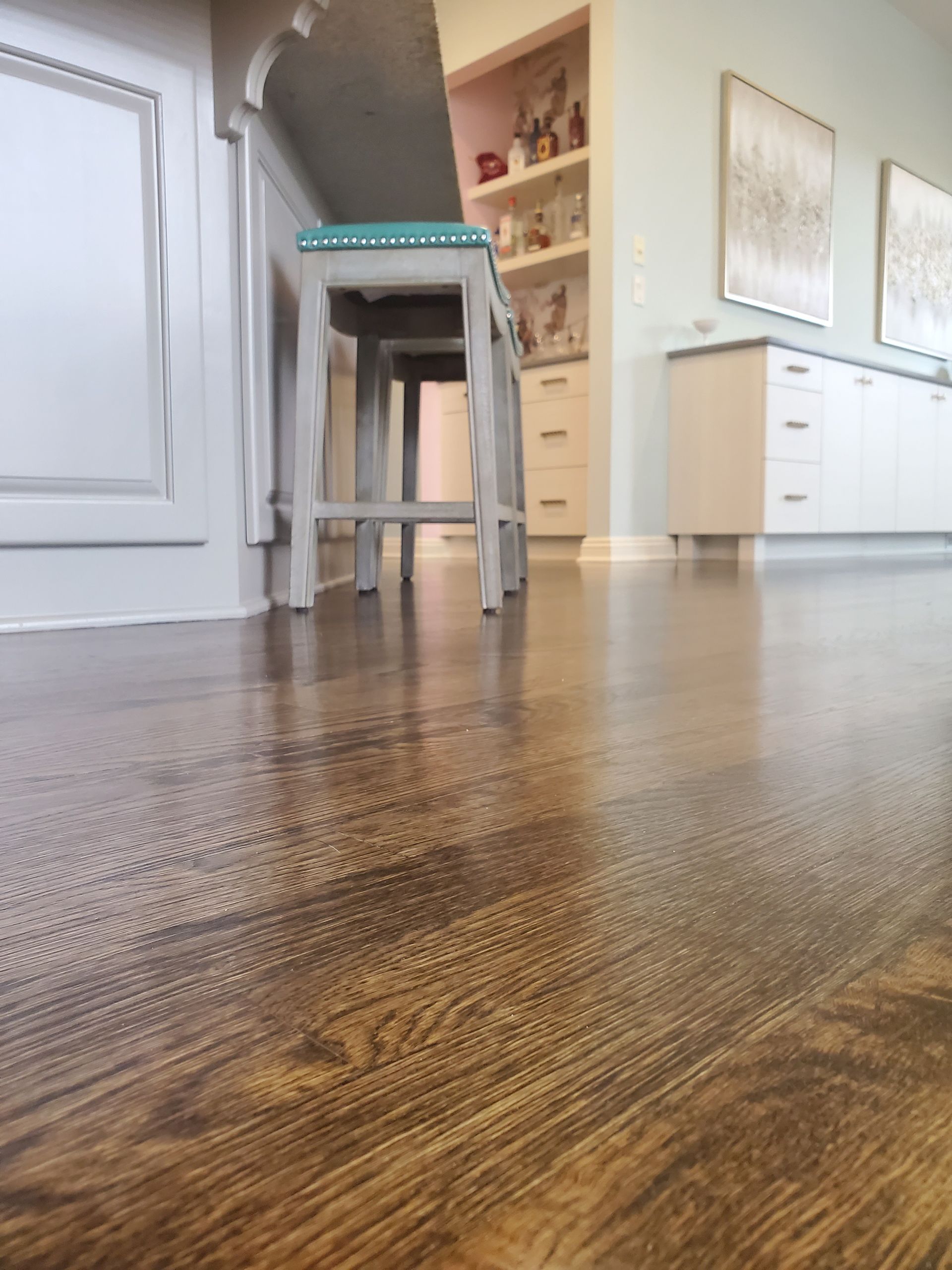 A Wooden Floor in a Kitchen With Two Stools and a Table — Omaha, NE — Ohana Wood Floors Inc.