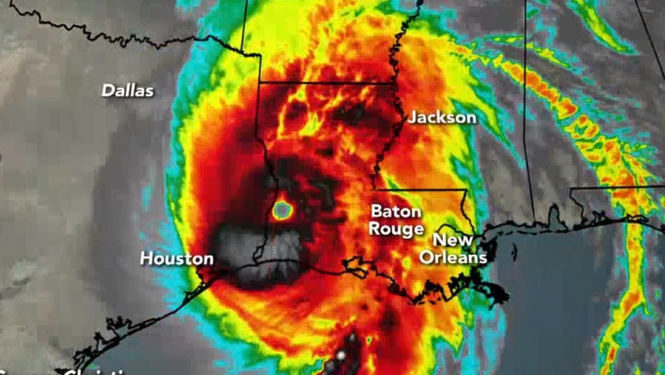 Satellite view of a hurricane over the Gulf Coast, with red and yellow swirling clouds, impacting Houston and New Orleans.