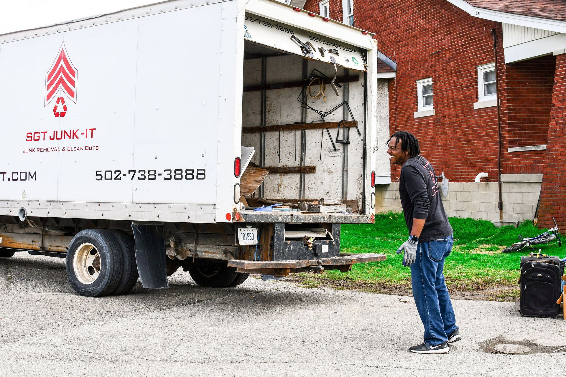 Man loads a white truck labeled 