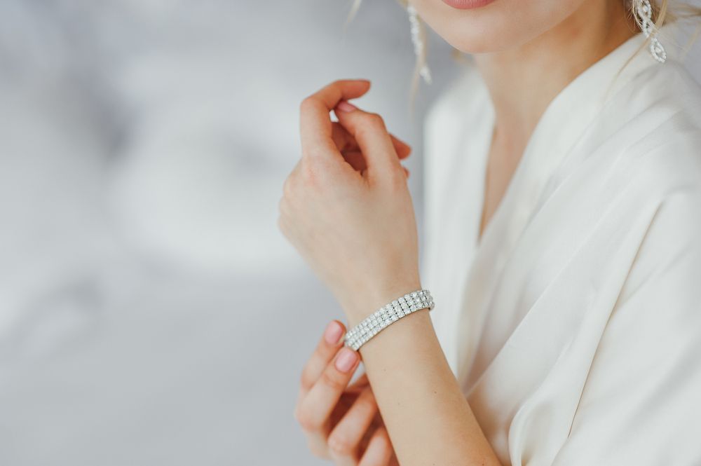 A close up of a woman wearing a bracelet on her wrist.