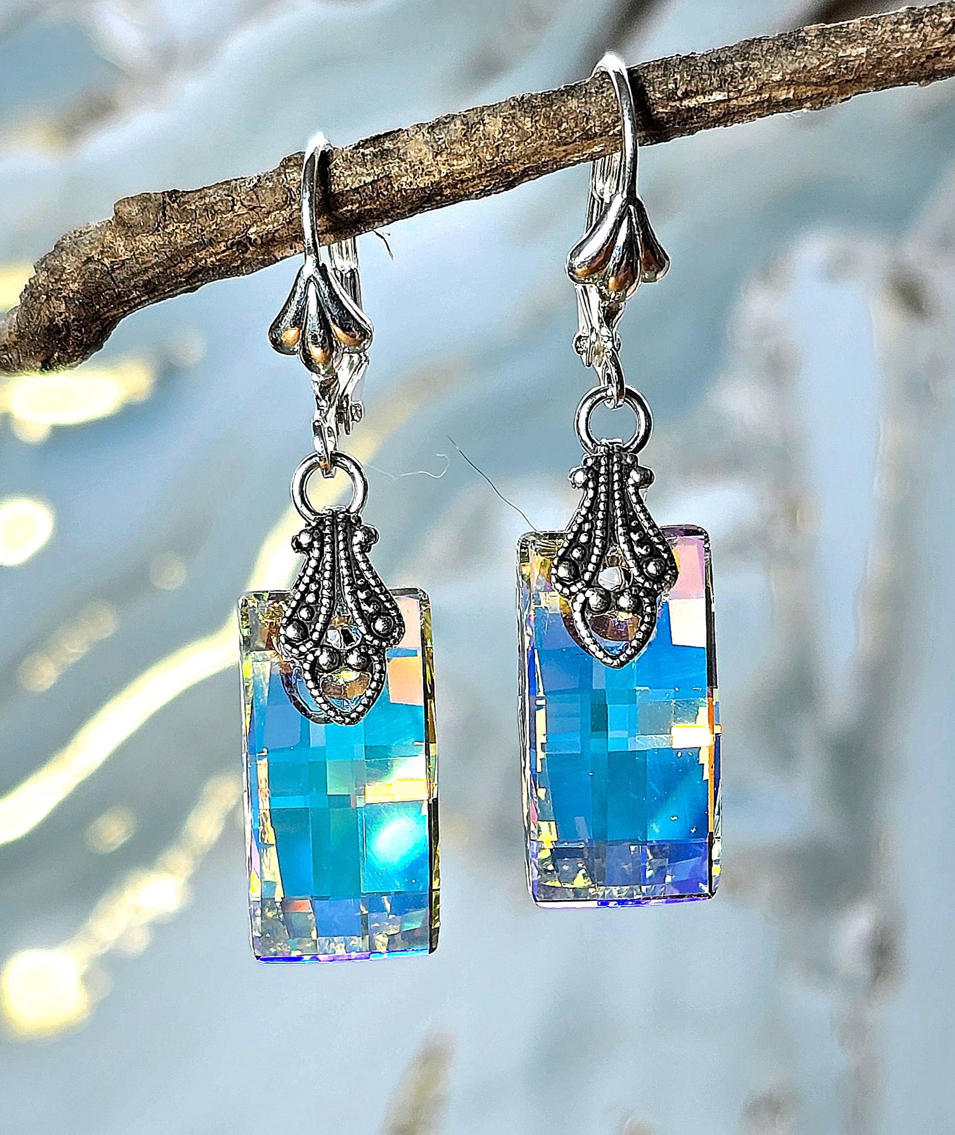 A pair of earrings hanging from a tree branch