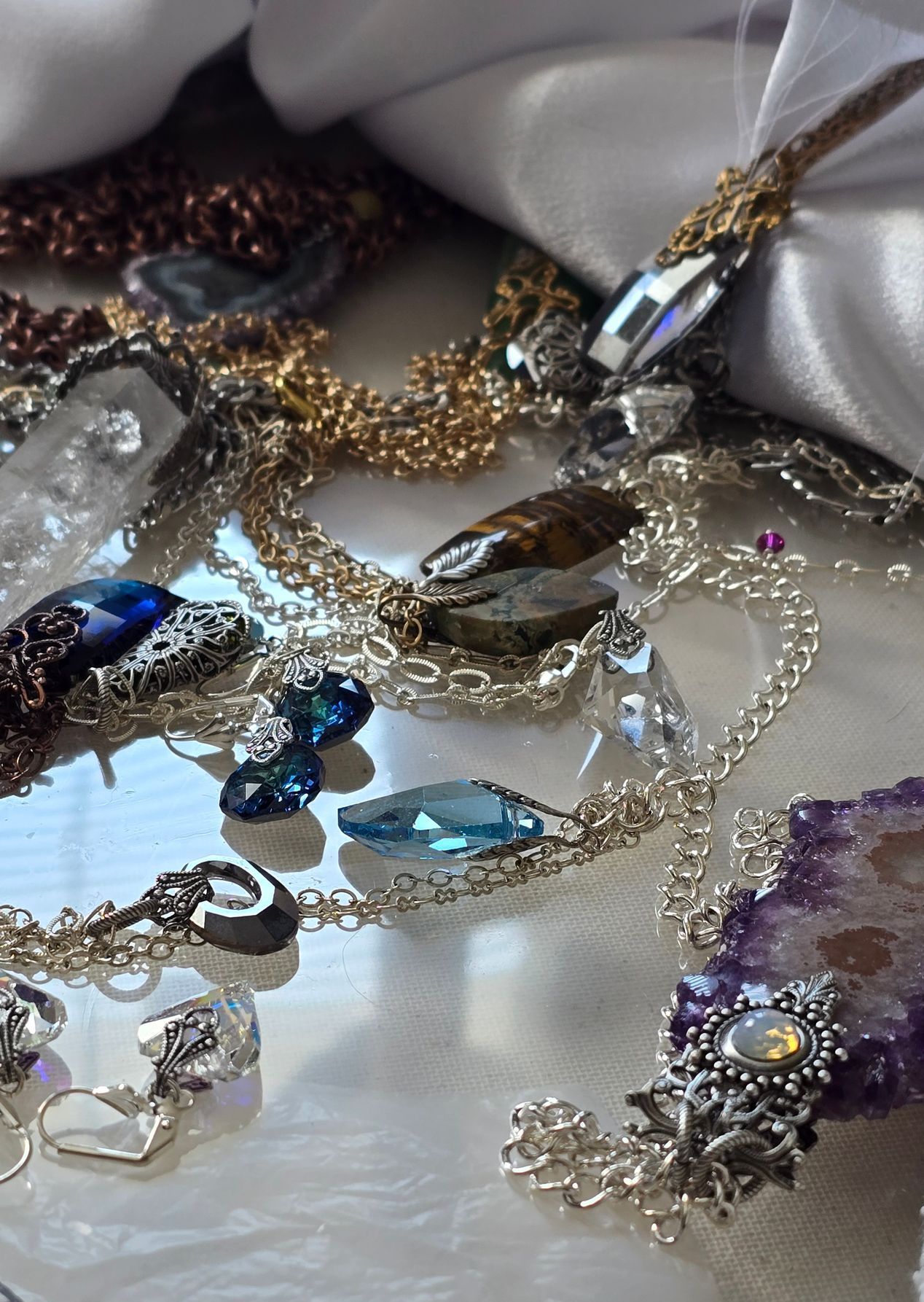 There are many different types of jewelry on the table.