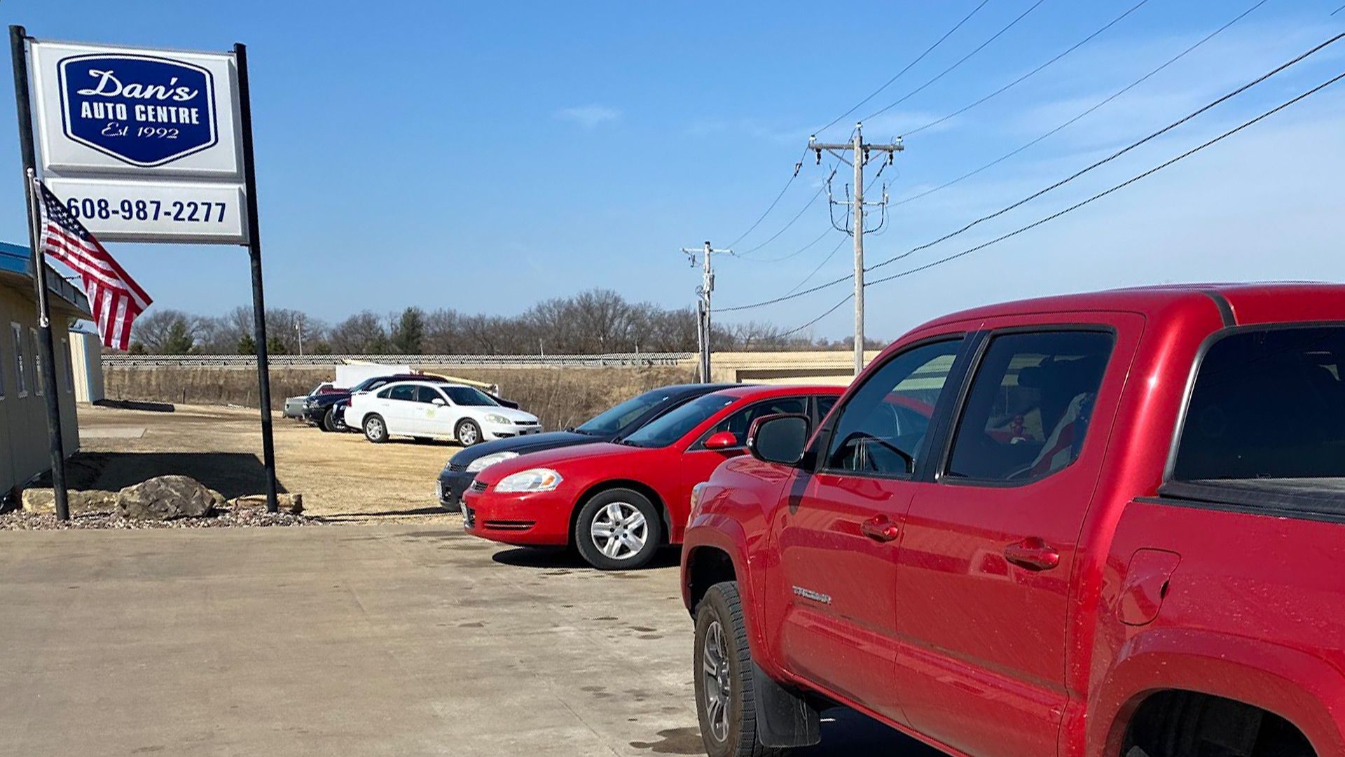 A White Car Is on a Lift in a Garage | Dan's Auto Centre