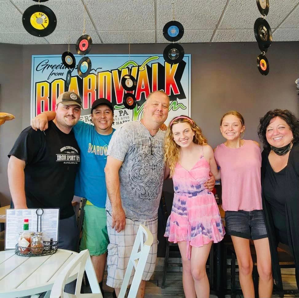 A group of people posing for a picture in front of a sign that says ricardo salk