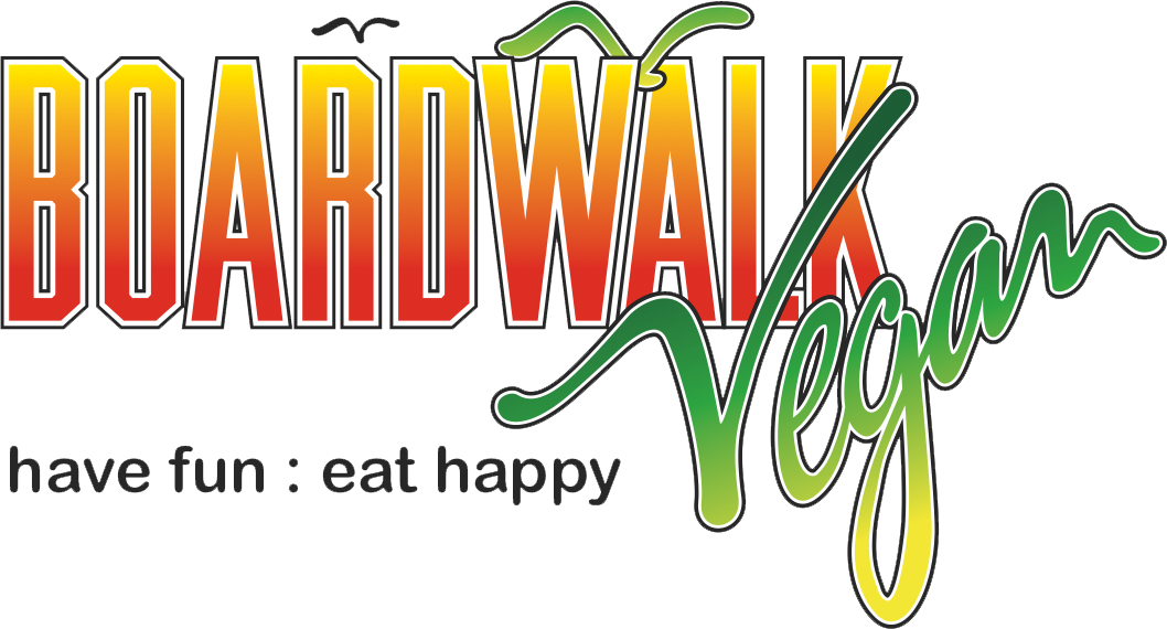 The logo for boardwalk vegan says have fun eat happy.