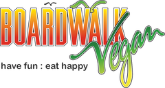 The logo for boardwalk vegan says have fun eat happy.