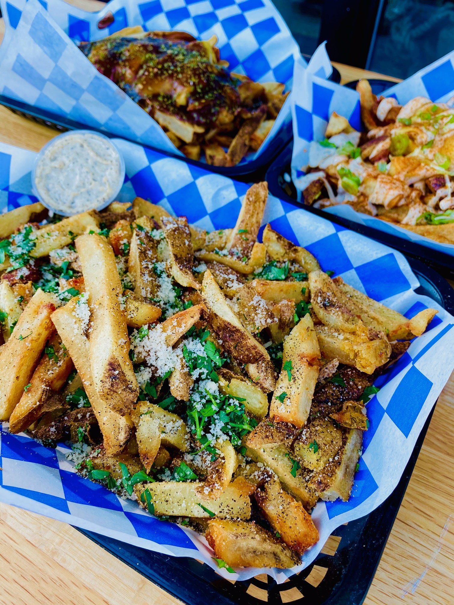 A close up of a plate of french fries on a table.