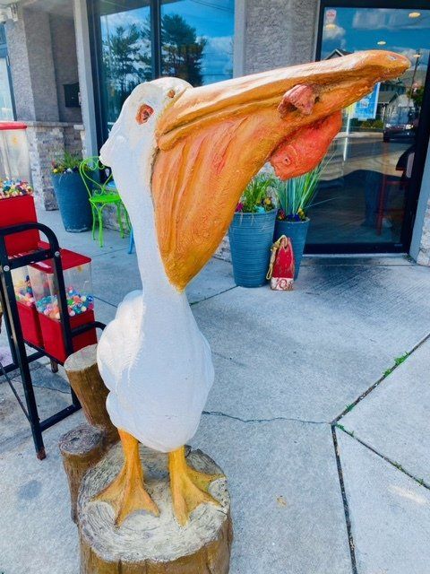 A statue of a pelican with its mouth open