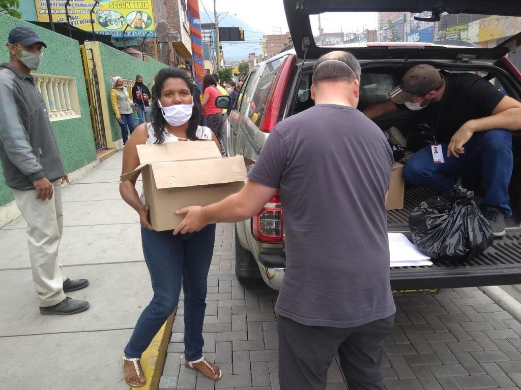 Workers unload boxes of food as part of COVID-19 ministry