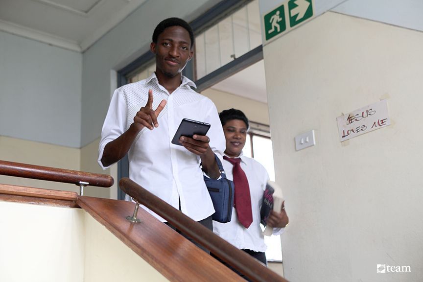 Durban Bible College students walk downstairs.