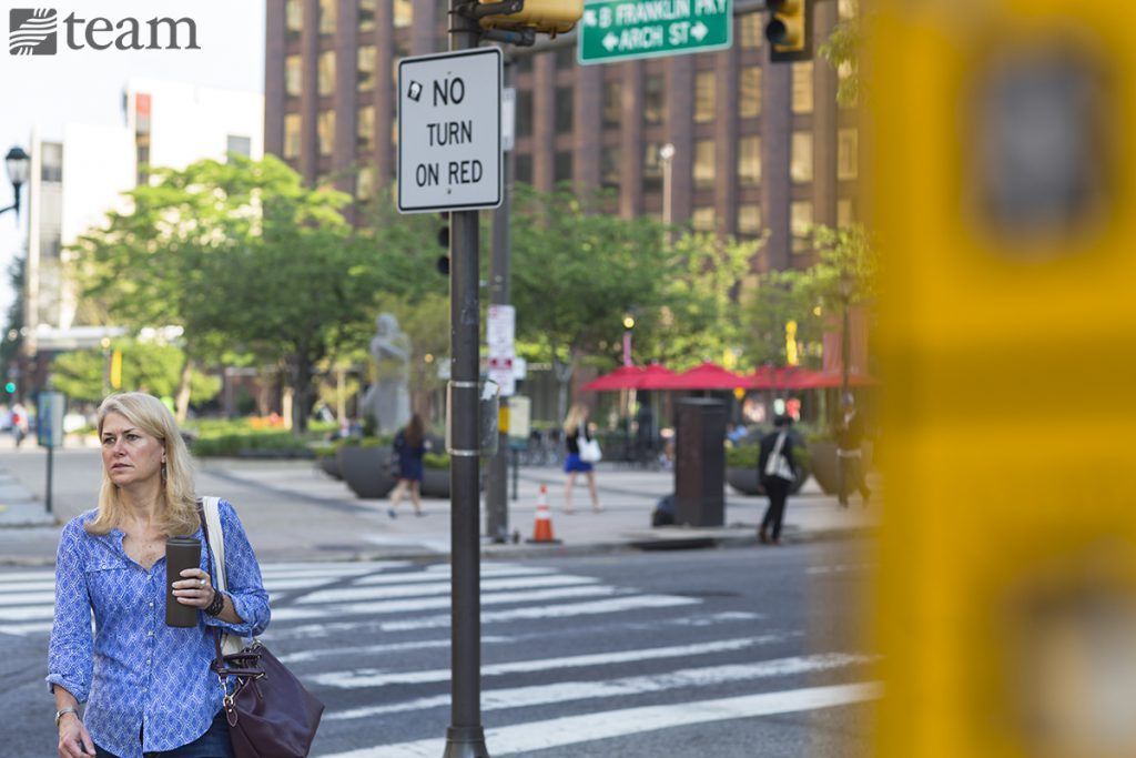 A woman crosses the street in Philadelphia