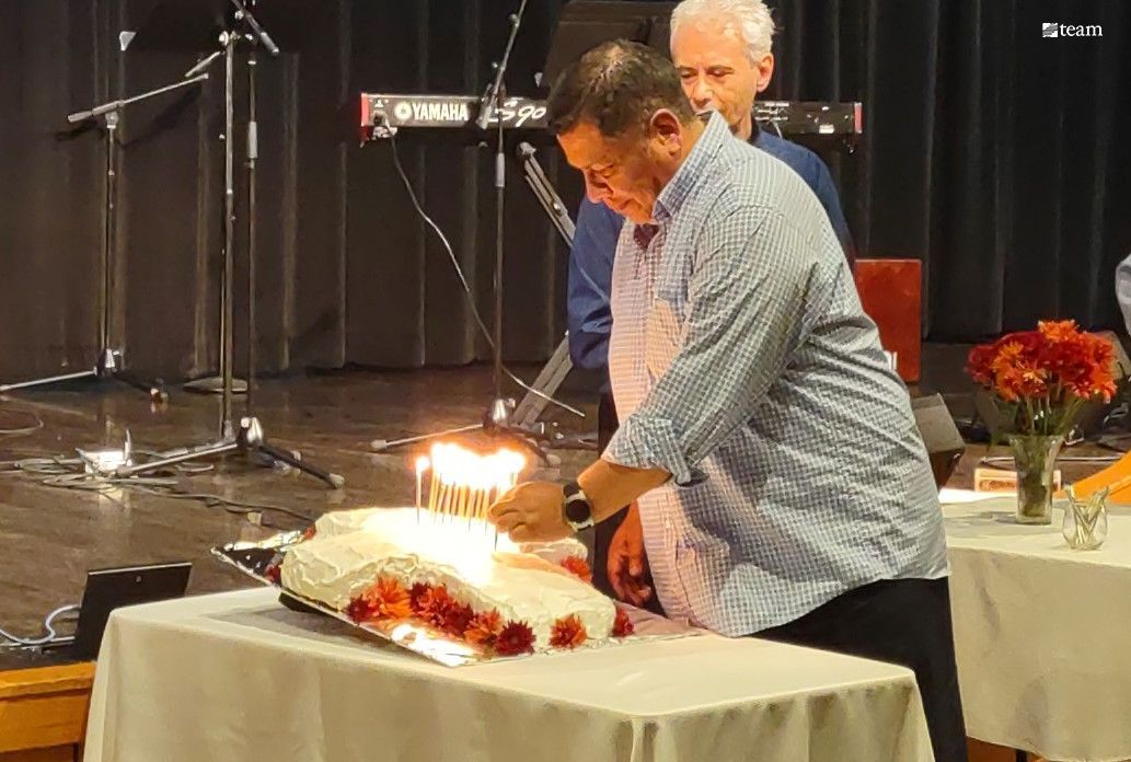 Man adding candles to a cake.