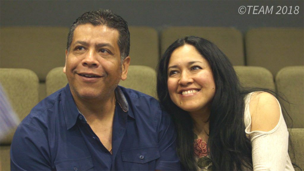 Julio and Libia sit together in church at Impacto Charlotte
