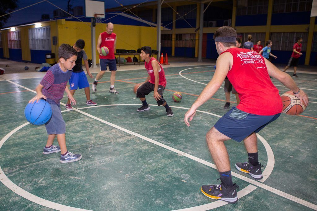 Mexican children play basketball at Transformados