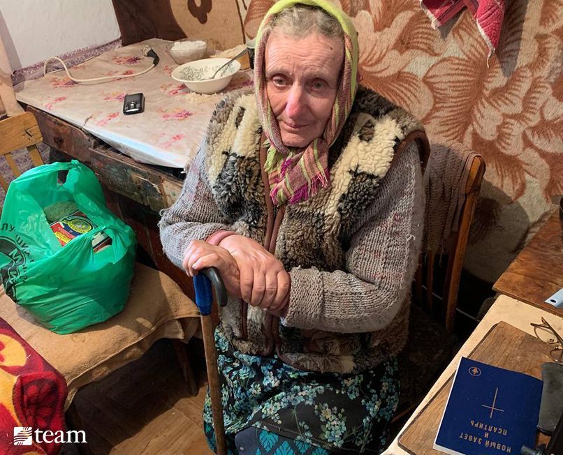 Ukrainian lady sitting with Bible