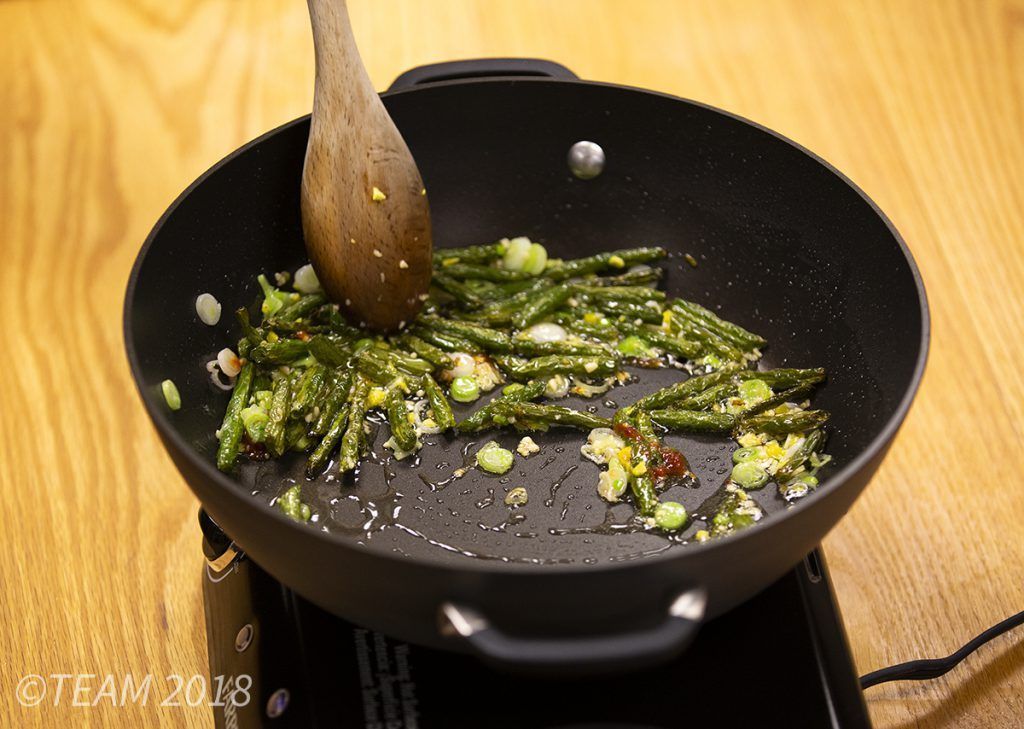 All of the other ingredients are added to the stir fried green beans.