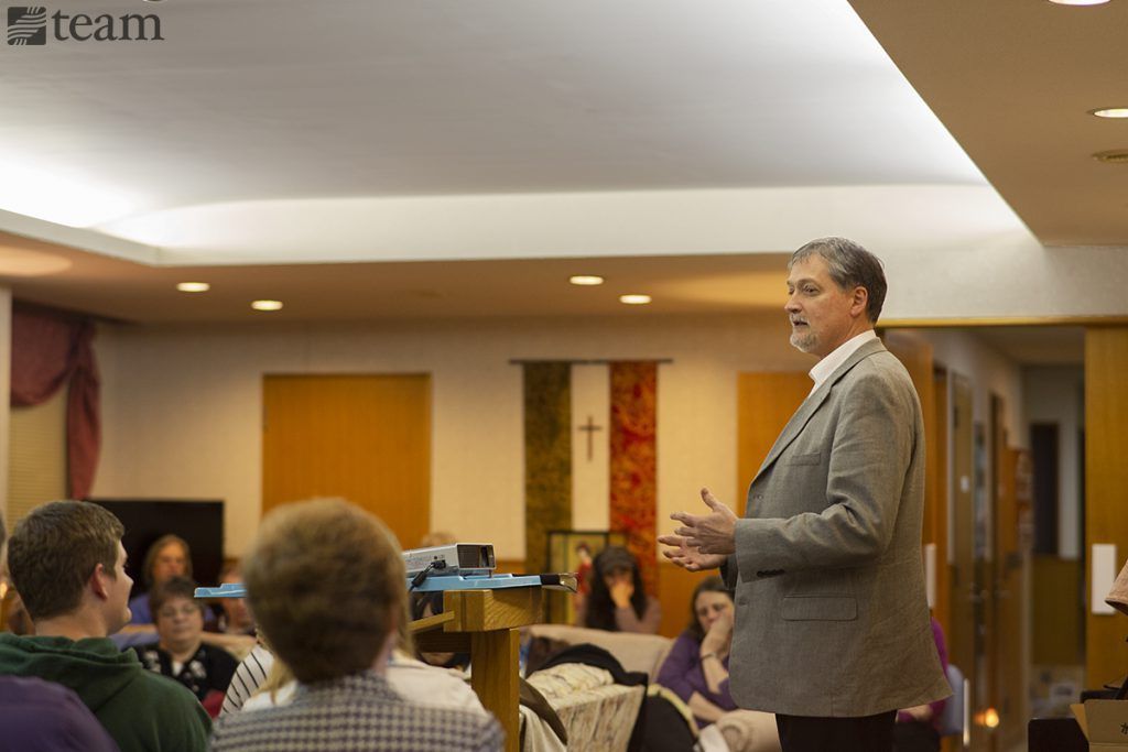 A missionary speaks at a conference.