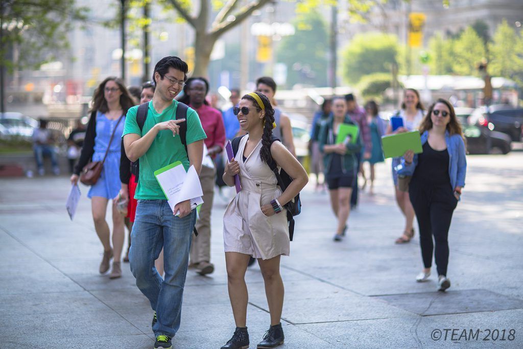 College age students talk while walking around downtown Philadelphia.