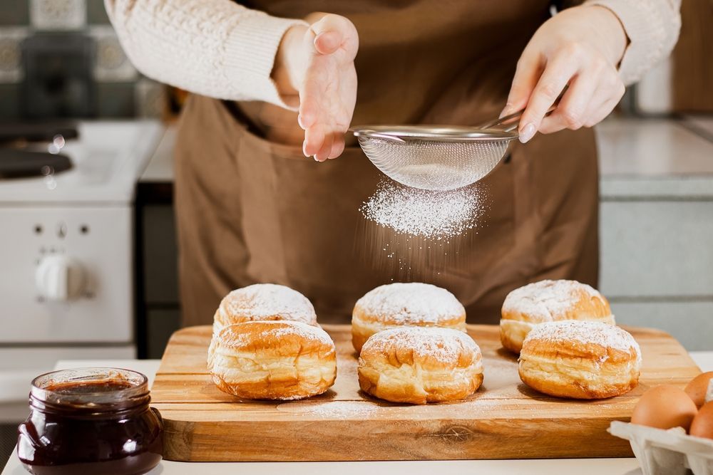 woman using powdered sugar in baking