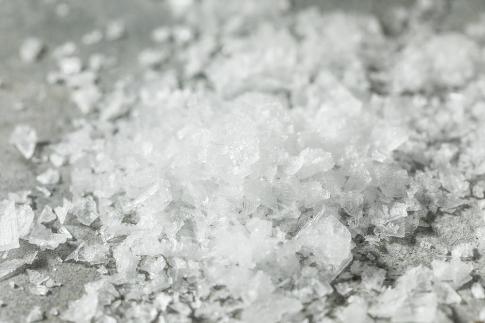 A close up of a pile of salt on a table.