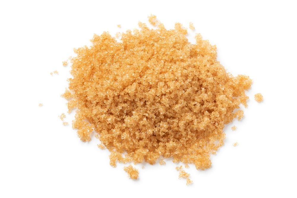 A pile of brown sugar on a white background.