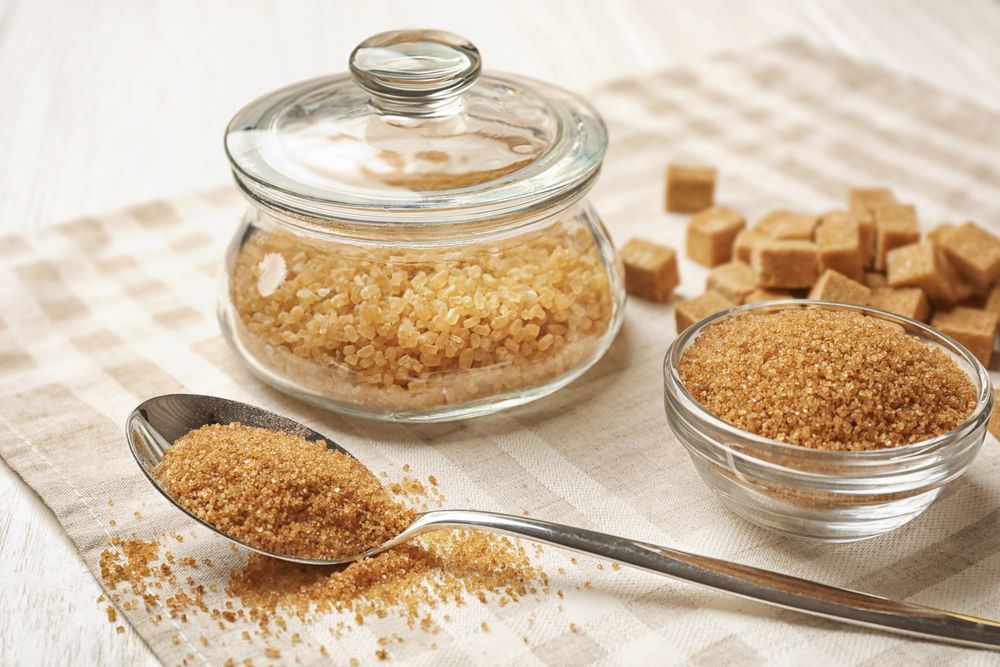 Bulk raw turbinado sugar in jar, in a bowl, and on a spoon