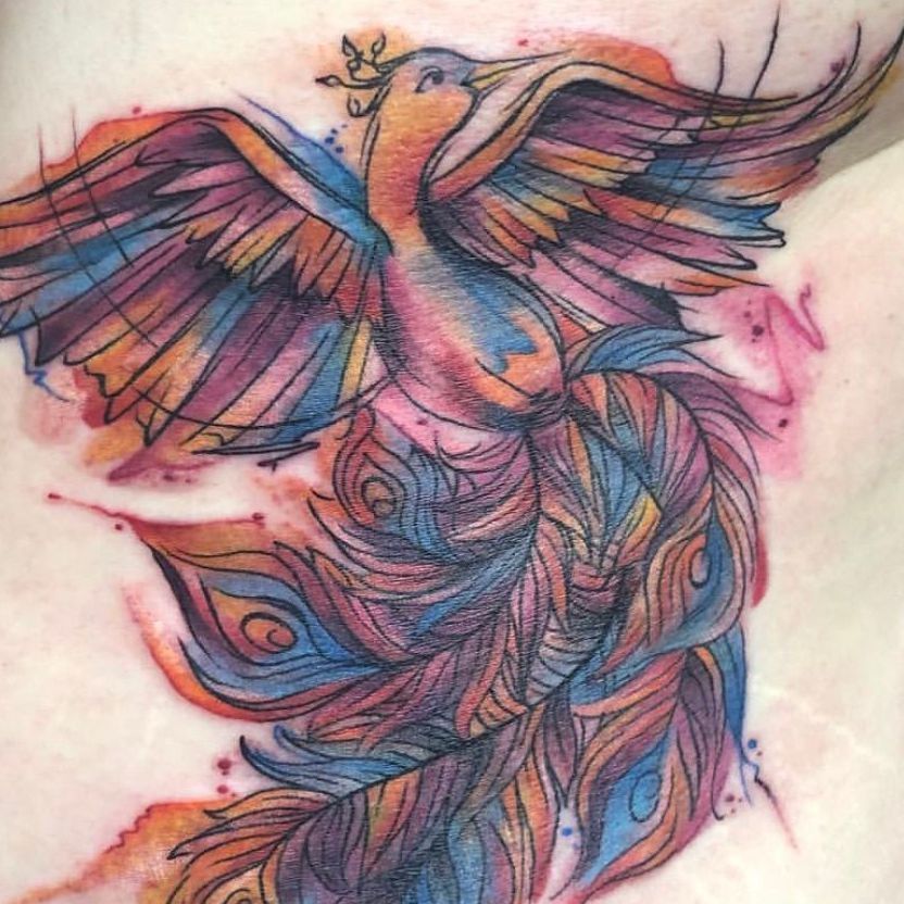 A colorful tattoo of a peacock with a crown on its head