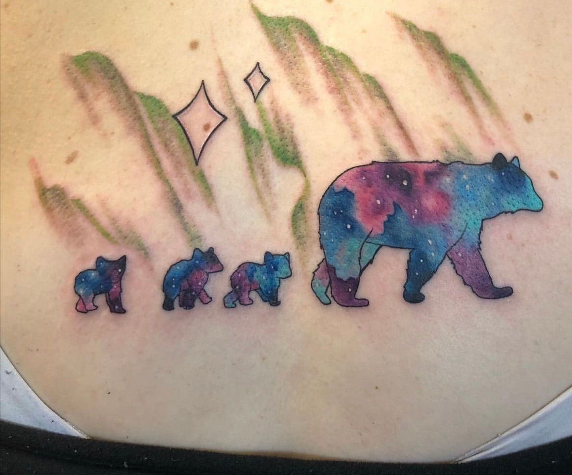 A woman has a tattoo of a mother bear and her three cubs