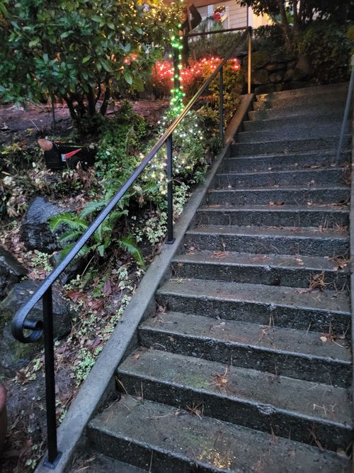 A set of stairs leading up to a house with a railing