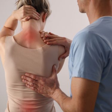 A woman is receiving chiropractic adjustments
